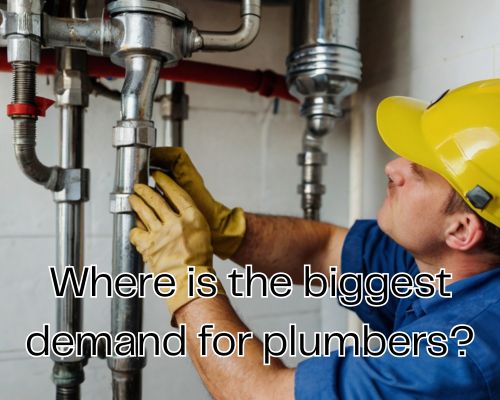 The plumber is working beneath a kitchen sink.